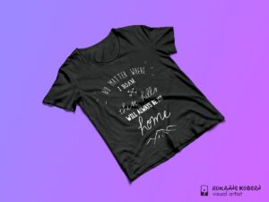 Black tshirt on purple background with quote: "No matter where I roam these hills will always be my home"