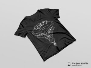 Black t-shirt on grey background with illustration of a Luna Moth covering the eye sockets of a cow skull. "Rest" by Sam Crabtree.